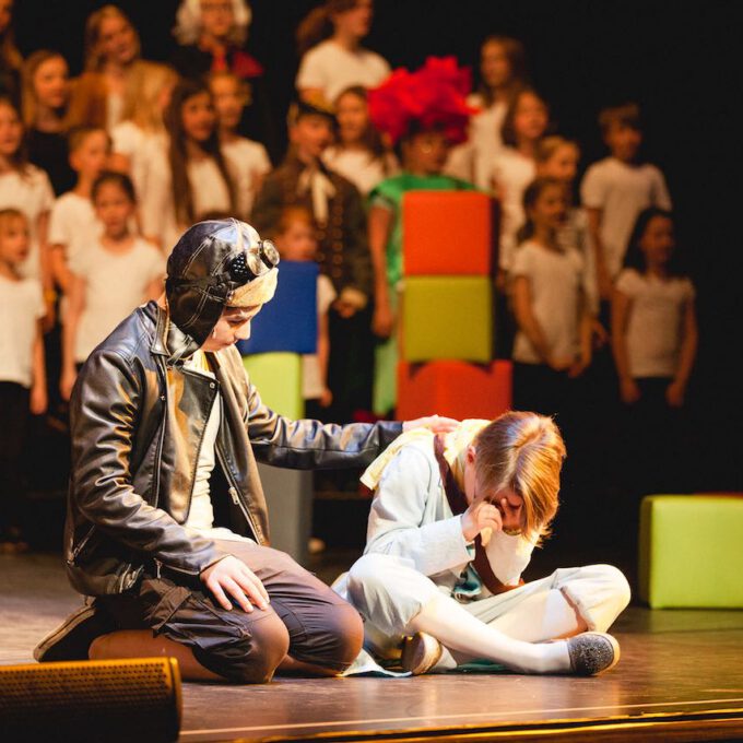 Der Pilot tröstet den "kleinen Prinzen", im Hintergrund der Kinderchor.